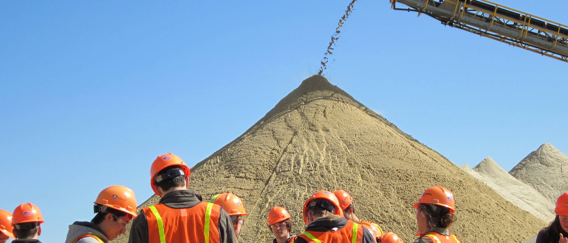 UW-Eau Claire students enrolled in Dr. Brian Mahoney's "Sedimentation and Stratigraphy" class examine grains of sand during a tour of Wisconsin Industrial Sand Co.'s mining operations.